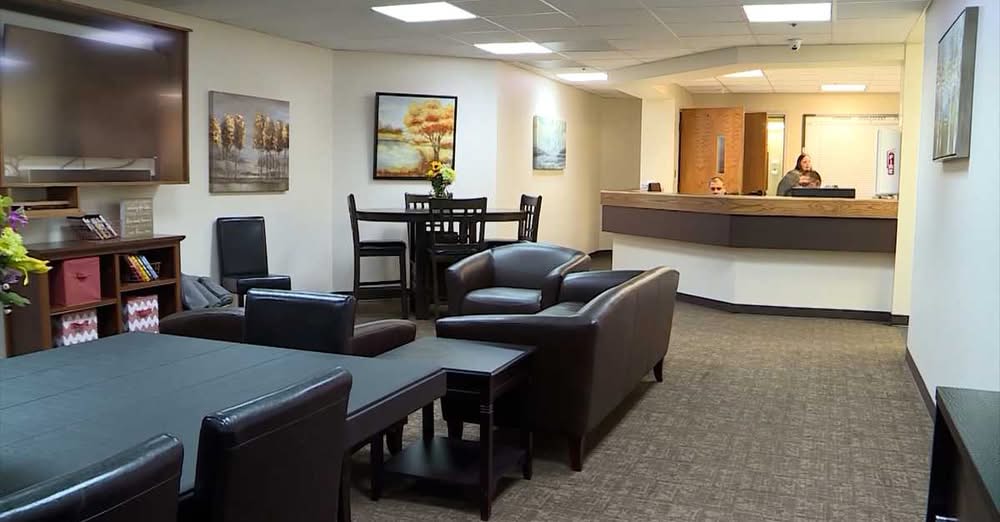 CSU common area with seating, tables, and a reception desk