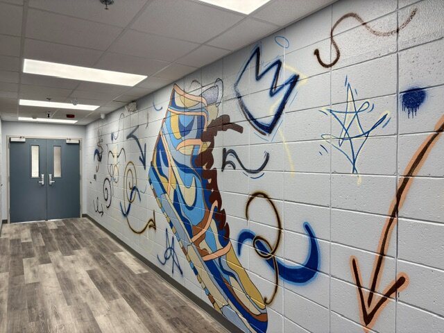 Hallway brightened with a hand-painted mural